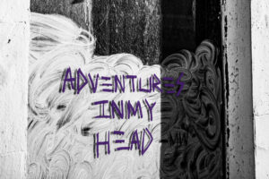 the identity trap. Black and white photo of a window with the words 'Adventures in my head' written in purple. An abstract image representing identity and mindset.